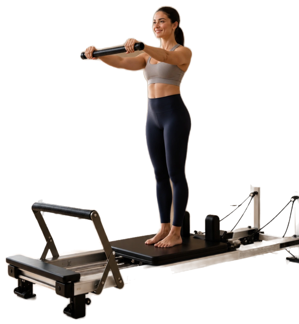A teacher standing on the carriage of a reformer holding the bar out in front of her.